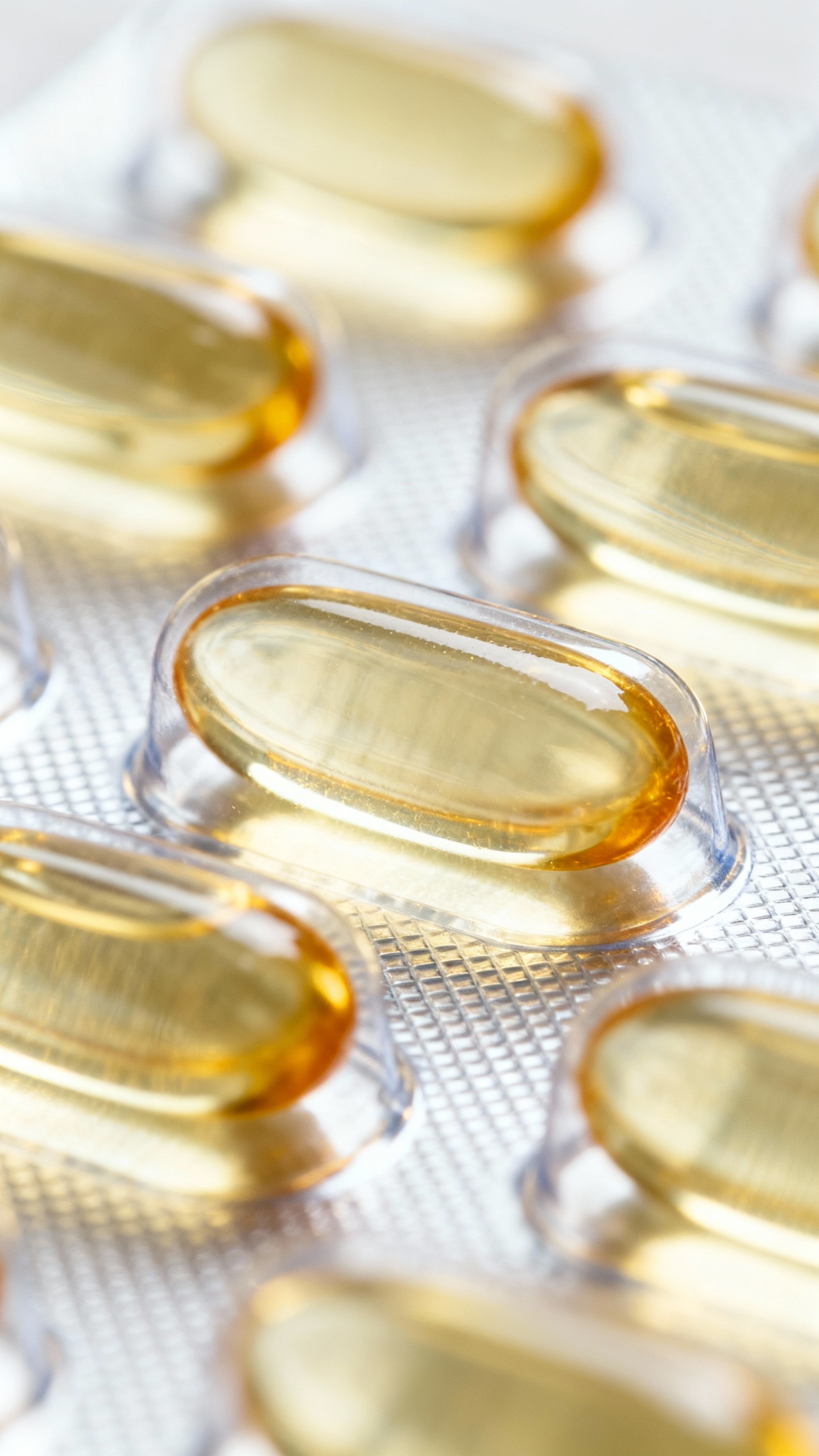 DHA omega-3 fish oil capsules in clear blister pack, macro shot